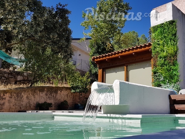 Piscina desbordante con cascada y jardin vertical en Valdemorillo