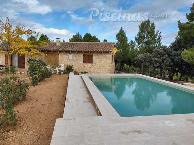 Piscina con entorno de piedra.